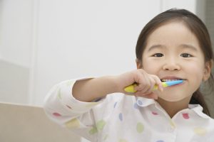 Young Girl Brushing Her Teeth